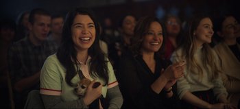Movie still from “All Together Now” (2020), directed by Brett Haley – Two women are laughing and clapping in a theater; Medium shot, Over the shoulder angle