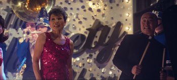 Movie still from “All Together Now” (2020), directed by Brett Haley – A woman in a red dress standing in front of a mirror; Medium shot, Over the shoulder angle