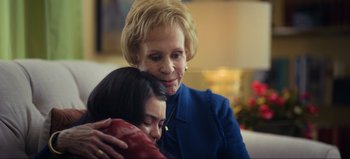 Movie still from “All Together Now” (2020), directed by Brett Haley – A woman is hugging a woman in a blue suit; Close Up shot, Over the shoulder angle