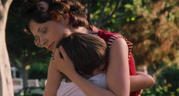 Movie still from “Almost Famous” (2000), directed by Cameron Crowe – A woman holding a child in her arms; Close Up shot, Over the shoulder angle