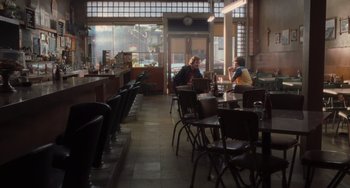 Movie still from “Almost Famous” (2000), directed by Cameron Crowe – Two people sitting at a table in a restaurant; Wide shot, Over the shoulder angle