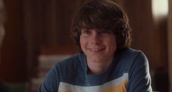 Movie still from “Almost Famous” (2000), directed by Cameron Crowe – A young man with brown hair and a blue and white striped shirt; Close Up shot, Over the shoulder angle