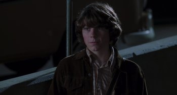 Movie still from “Almost Famous” (2000), directed by Cameron Crowe – A young man with long hair wearing a brown jacket; Close Up shot, Low angle