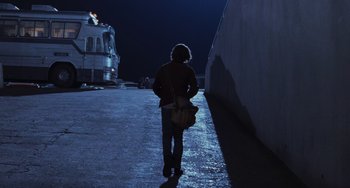 Movie still from “Almost Famous” (2000), directed by Cameron Crowe – A person standing on the side of a road at night; Wide shot, Low angle