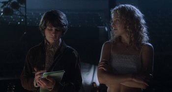Movie still from “Almost Famous” (2000), directed by Cameron Crowe – A man and a woman standing next to each other; Medium shot, Low angle
