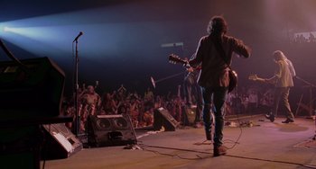 Movie still from “Almost Famous” (2000), directed by Cameron Crowe – A man with a guitar in front of an audience; Wide shot, Low angle
