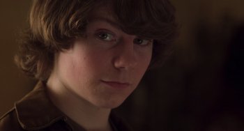 Movie still from “Almost Famous” (2000), directed by Cameron Crowe – A person's face in the dark; Close Up shot, High angle