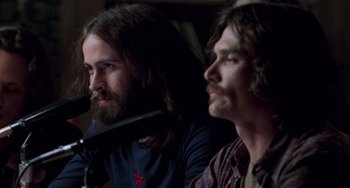 Movie still from “Almost Famous” (2000), directed by Cameron Crowe – A man with long hair sitting next to another man with long hair; Close Up shot, Over the shoulder angle