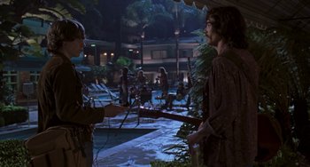 Movie still from “Almost Famous” (2000), directed by Cameron Crowe – Two people standing in a courtyard at night; Medium shot, Over the shoulder angle