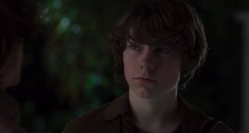 Movie still from “Almost Famous” (2000), directed by Cameron Crowe – A young man with long brown hair wearing a brown shirt; Close Up shot, Over the shoulder angle