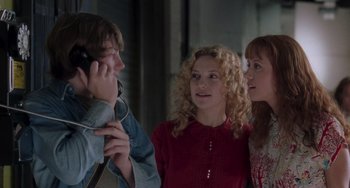 Movie still from “Almost Famous” (2000), directed by Cameron Crowe – A group of people standing next to each other; Medium shot, Over the shoulder angle