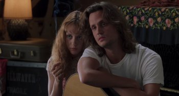 Movie still from “Almost Famous” (2000), directed by Cameron Crowe – A man and a woman sitting next to each other with a guitar; Close Up shot, Low angle