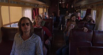 Movie still from “Almost Famous” (2000), directed by Cameron Crowe – A group of people sitting in a train car; Wide shot, Over the shoulder angle