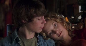 Movie still from “Almost Famous” (2000), directed by Cameron Crowe – A boy and a girl sitting next to each other; Close Up shot, Overhead angle