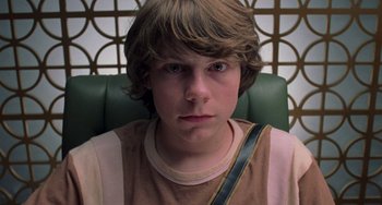 Movie still from “Almost Famous” (2000), directed by Cameron Crowe – A young man sitting in a green chair; Close Up shot, Low angle