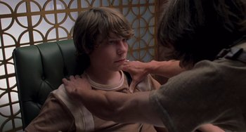 Movie still from “Almost Famous” (2000), directed by Cameron Crowe – A person is helping another person with his shirt; Close Up shot, Over the shoulder angle