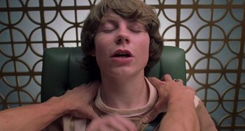 Movie still from “Almost Famous” (2000), directed by Cameron Crowe – A person is holding a person's hand over a man's chest; Close Up shot, Overhead angle
