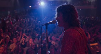 Movie still from “Almost Famous” (2000), directed by Cameron Crowe – A person on a stage singing into a microphone; Medium shot, Low angle
