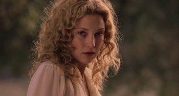 Movie still from “Almost Famous” (2000), directed by Cameron Crowe – A person with curly blonde hair; Close Up shot, Over the shoulder angle