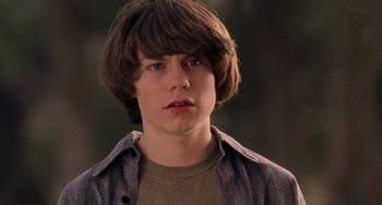 Movie still from “Almost Famous” (2000), directed by Cameron Crowe – A young man with brown hair wearing a brown t - shirt; Close Up shot, Low angle
