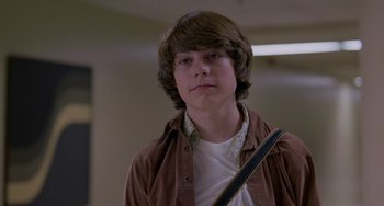 Movie still from “Almost Famous” (2000), directed by Cameron Crowe – A young man wearing a brown jacket and a white shirt; Close Up shot, Low angle