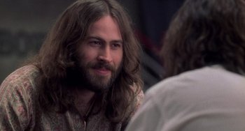 Movie still from “Almost Famous” (2000), directed by Cameron Crowe – A man with long hair and a long beard; Close Up shot, Over the shoulder angle