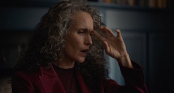 Movie still from “Along for the Ride” (2022), directed by Sofia Alvarez – An older woman with curly grey hair touching her hair; Close Up shot, Over the shoulder angle