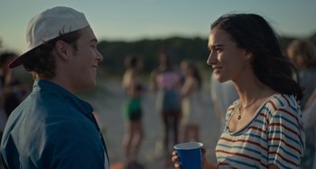 Movie still from “Along for the Ride” (2022), directed by Sofia Alvarez – A man and a woman are talking to each other; Close Up shot, Over the shoulder angle