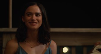 Movie still from “Along for the Ride” (2022), directed by Sofia Alvarez – A person smiling at the camera; Close Up shot, Over the shoulder angle