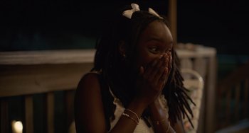 Movie still from “Along for the Ride” (2022), directed by Sofia Alvarez – A young girl covers her face with her hands; Close Up shot, Over the shoulder angle