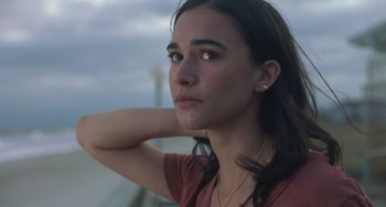 Movie still from “Along for the Ride” (2022), directed by Sofia Alvarez – A beautiful young lady looking off into the distance; Close Up shot, Low angle