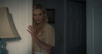 Movie still from “Along for the Ride” (2022), directed by Sofia Alvarez – A woman standing in front of a white door; Medium shot, Over the shoulder angle
