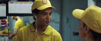 Movie still from “American Carnage” (2022), directed by Diego Hallivis – A man in a yellow shirt and a yellow hat; Close Up shot, Over the shoulder angle