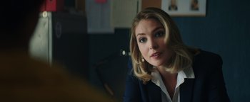 Movie still from “American Carnage” (2022), directed by Diego Hallivis – A person sitting in a room; Close Up shot, Over the shoulder angle