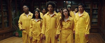 Movie still from “American Carnage” (2022), directed by Diego Hallivis – A group of young people standing in yellow uniforms; Medium shot, Low angle