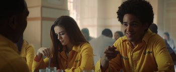 Movie still from “American Carnage” (2022), directed by Diego Hallivis – A woman and a man sitting at a table in a restaurant; Medium shot, Over the shoulder angle