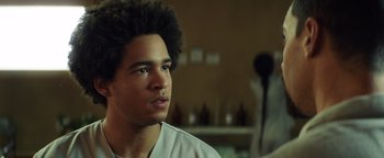 Movie still from “American Carnage” (2022), directed by Diego Hallivis – A young man with a beard is looking into the distance; Close Up shot, Low angle