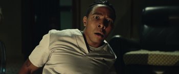 Movie still from “American Carnage” (2022), directed by Diego Hallivis – A person wearing a white shirt; Close Up shot, Low angle