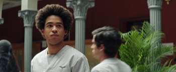 Movie still from “American Carnage” (2022), directed by Diego Hallivis – Two men in white shirts are standing in front of a mirror; Close Up shot, Low angle