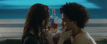 Movie still from “American Carnage” (2022), directed by Diego Hallivis – A man and a woman sitting next to each other at a table; Close Up shot, Over the shoulder angle