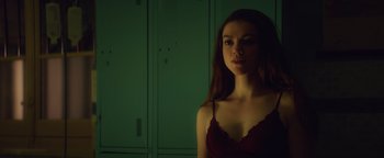 Movie still from “American Carnage” (2022), directed by Diego Hallivis – A woman in a red bra standing in front of a closet; Close Up shot, Low angle