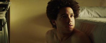 Movie still from “American Carnage” (2022), directed by Diego Hallivis – A young man with a beard is looking into the distance; Close Up shot, Low angle