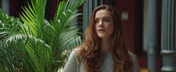 Movie still from “American Carnage” (2022), directed by Diego Hallivis – A beautiful young woman with long , red hair; Close Up shot, Low angle