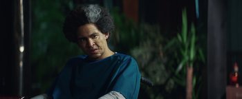 Movie still from “American Carnage” (2022), directed by Diego Hallivis – A man in a blue shirt with a white shirt on; Close Up shot, Low angle