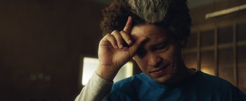 Movie still from “American Carnage” (2022), directed by Diego Hallivis – A person with a hand on their head; Close Up shot, Low angle