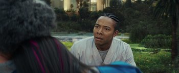 Movie still from “American Carnage” (2022), directed by Diego Hallivis – A man in a white shirt is talking to a woman; Close Up shot, Over the shoulder angle