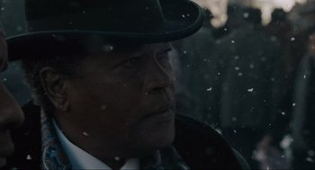 Movie still from “American Gangster” (2007), directed by Ridley Scott – A man wearing a hat looking out of a car window; Close Up shot, Over the shoulder angle