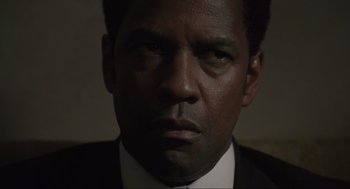 Movie still from “American Gangster” (2007), directed by Ridley Scott – A man in a black suit; Close Up shot, Low angle