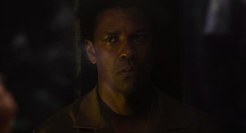 Movie still from “American Gangster” (2007), directed by Ridley Scott – A person wearing a brown jacket; Close Up shot, Low angle