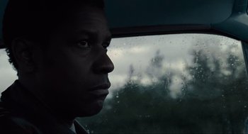 Movie still from “American Gangster” (2007), directed by Ridley Scott – A person looking out of a car window; Close Up shot, Low angle